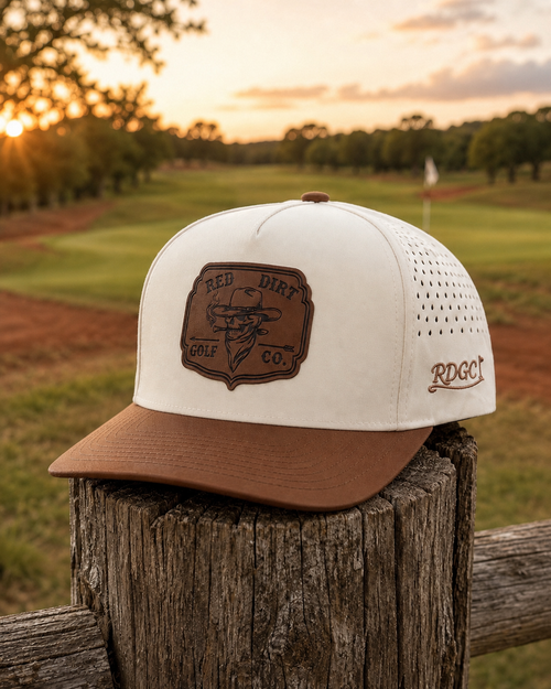 Sand Trap Hat on rustic fence post at golden hour